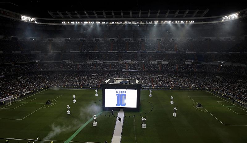 Huge screens displaying the words "La Decima" (The Tenth) and replicas of Real Madrid's Champions League trophies are seen in the pitch of Santiago Bernabeu stadium before a victory ceremony in Madrid