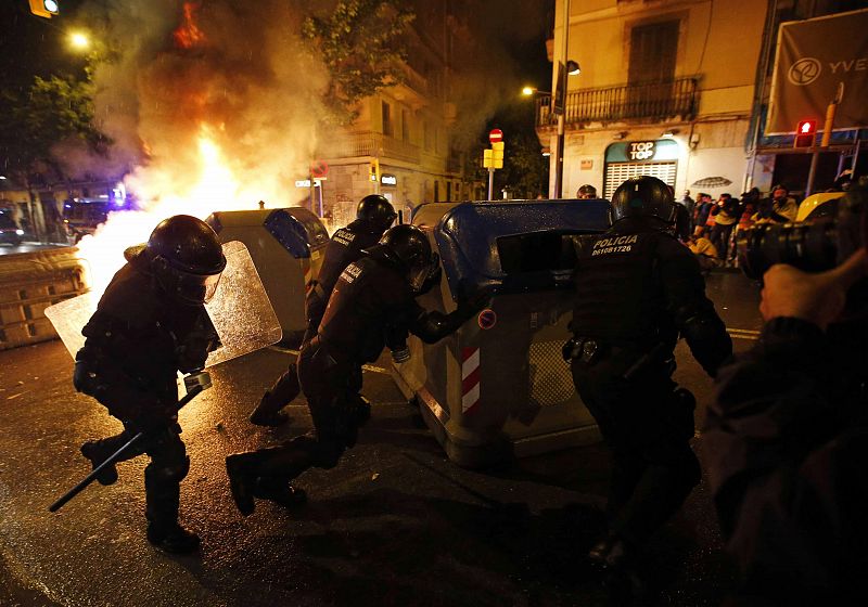 Police remove containers during a protest against the eviction of squatters from Can Vies building at Sants neighborhood in Barcelona