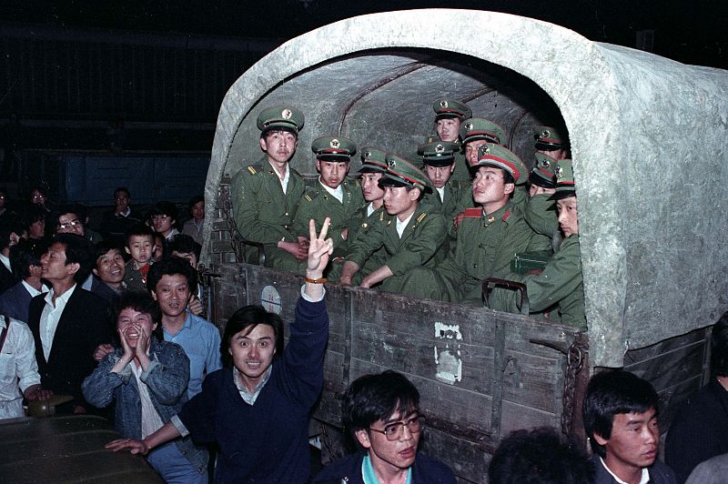 File photo of residents of Beijing surrounding an army convoy of 4,000 soldiers in a suburb of the city to prevent them from continuing to Tiananmen Square