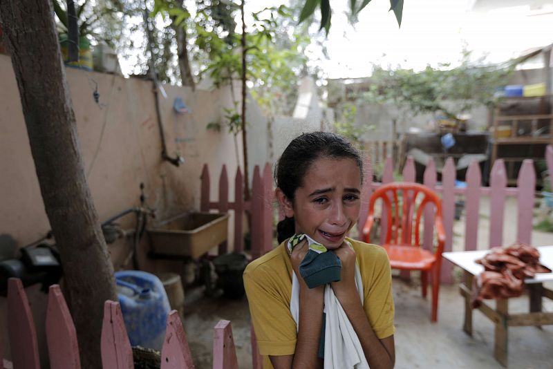 Una niña llora por la muerte de su hermano en el barrio gazatí de Shahiya.
