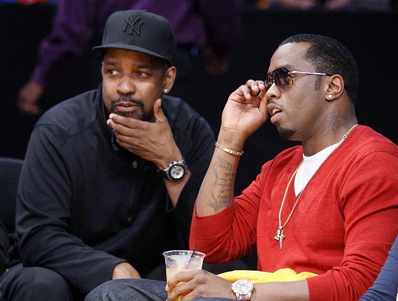 Actor Washington talks with singer P. Diddy as Lakers play Spurs during their NBA basketball playoff series in Los Angeles