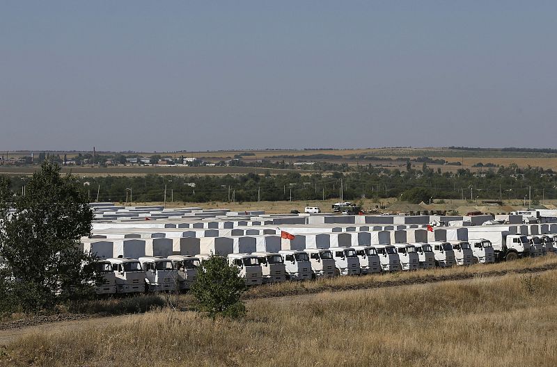 A Russian convoy of trucks carrying humanitarian aid for Ukraine is parked at a camp near Kamensk-Shakhtinsky