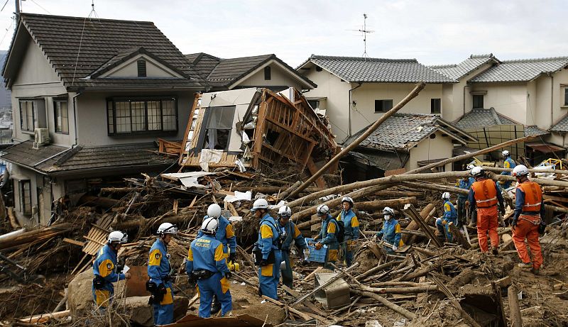 Policías y bomberos en busca de supervivientes en un área residencial de Hiroshima