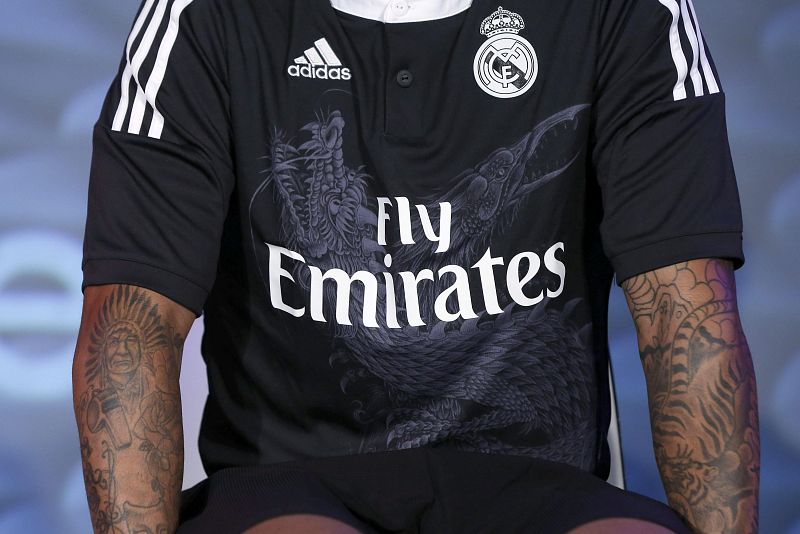 La nueva camiseta del Real Madrid de la firma Adidas es negra, con franjas blancas y con unos dragones entrelazados en la parte frontal como gran novedad.