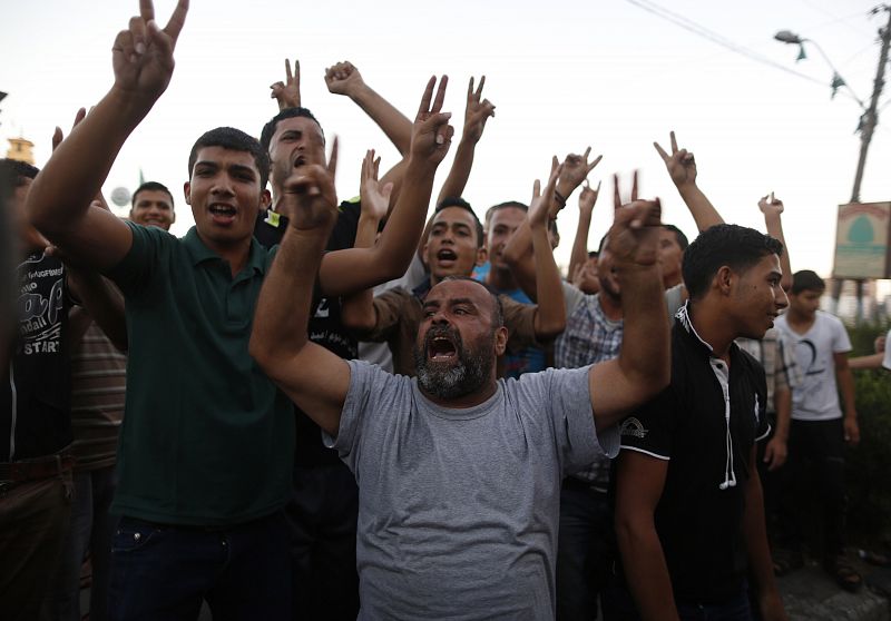 Palestinians celebrate what they said was a victory over Israel following a ceasefire, in Gaza City