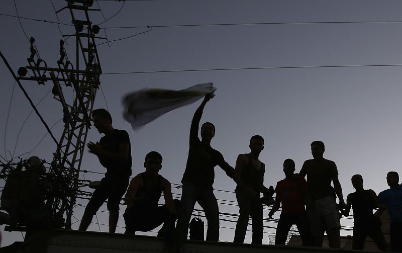 Palestinians celebrate what they said was a victory over Israel, following a ceasefire in Gaza City