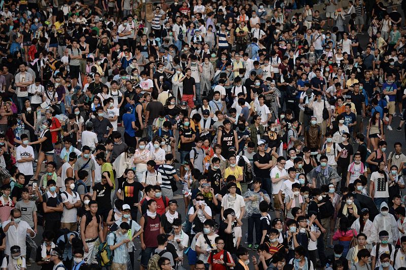 Los manifestantes descansan tras toda una noche de protestas a las puertas de la sede del Gobierno de Hong Kong.