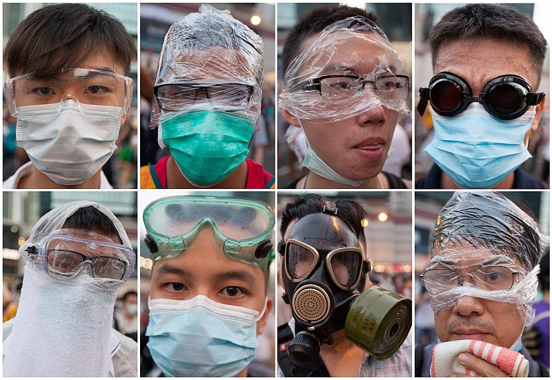 Manifestantes de Hong Kong con las caras tapadas para protegerse de los gases lacrimógenos