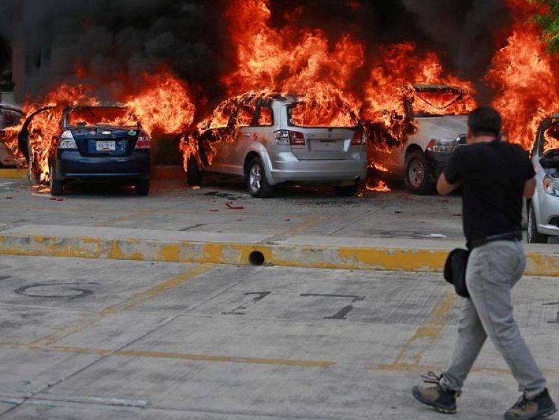 Varios coches aparcados frente a la sede parlamentaria han ardido. Foto: REUTERS/Jorge Dan Lopez