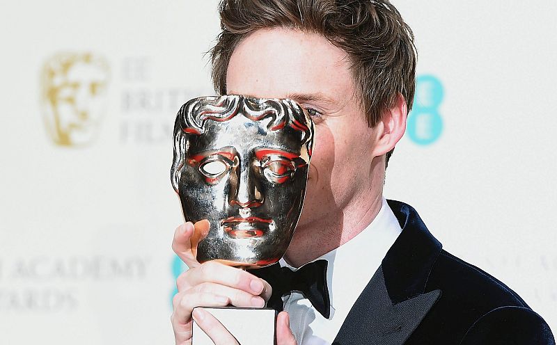 El actor británico Eddie Redmayne bromea con la prensa con su Bafta a mejor actor protagonista por 'La teoría del todo'.