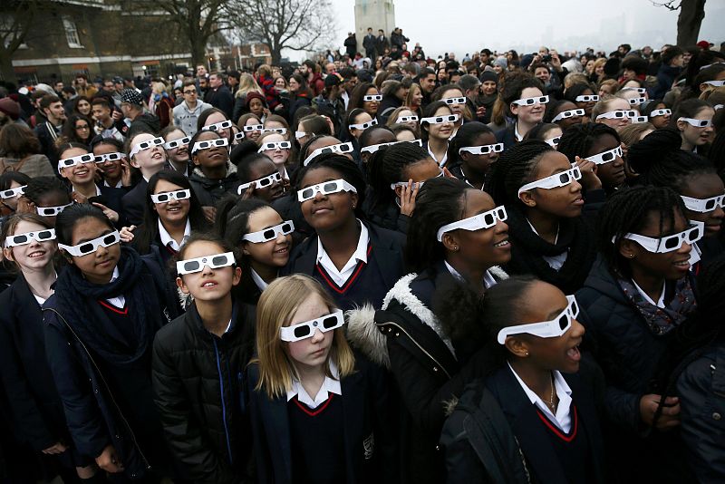 Un grupo de escolares observan el eclipse con las necesarias gafas especiales en Greenwich, al sureste de Londres.