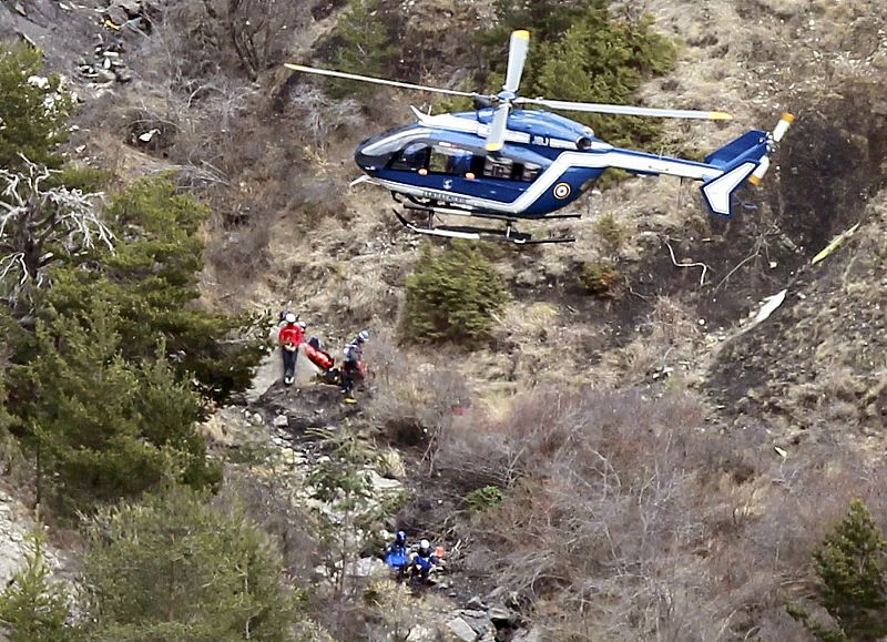 A French gendarme helicopter flies over the crash site of an Airbus A320, near Seyne-les-Alpes