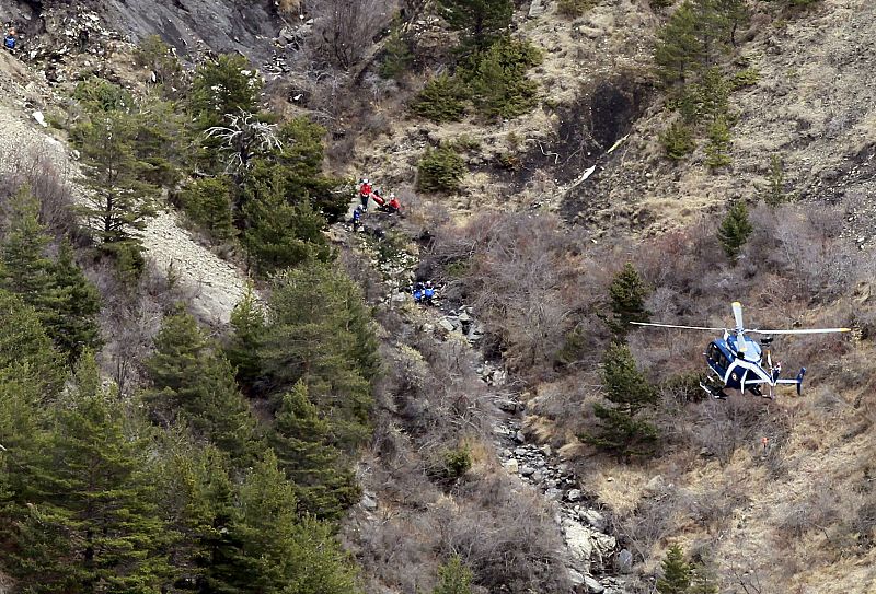 A French gendarme helicopter flies over the crash site of an Airbus A320, near Seyne-les-Alpes