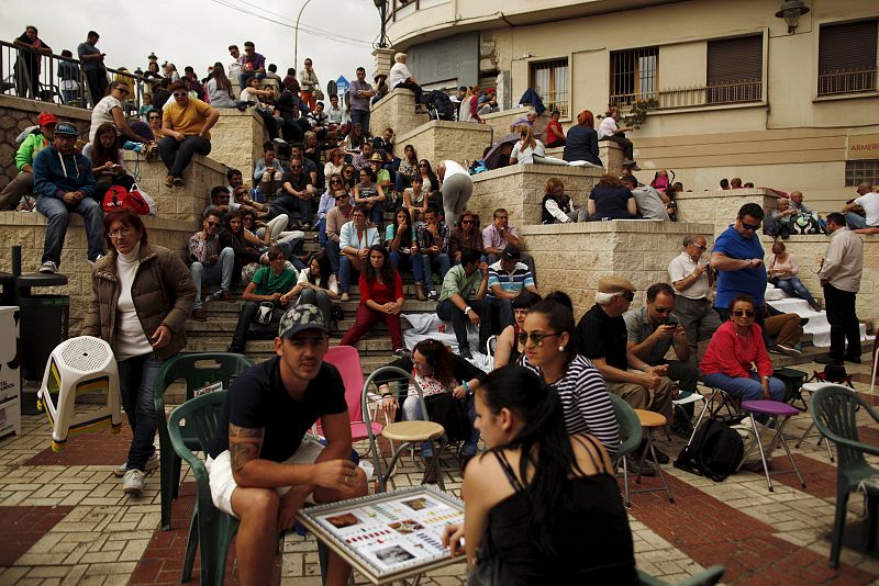 People wait to watch the "Vineros" brotherhood procession during Holy Week in Malaga