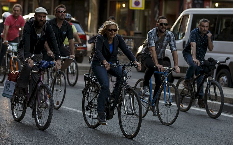 Carmena rides her bicycle through streets on her way to the closing electoral campaign rally before regional and municipal elections in Madrid