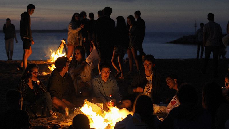 Youths burn their notes and notebooks at a bonfire during the traditional San Juan's (Saint John) night on the beach in Gijon