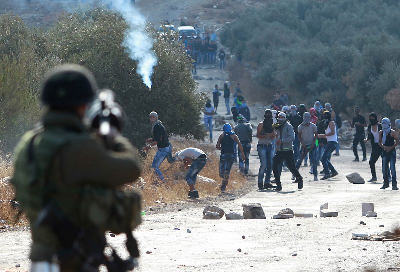 Manifestantes palestinos y las fuerzas de seguridad israelíes  se enfrentan en la ciudad palestina de Tuqua, al sureste de Belén.