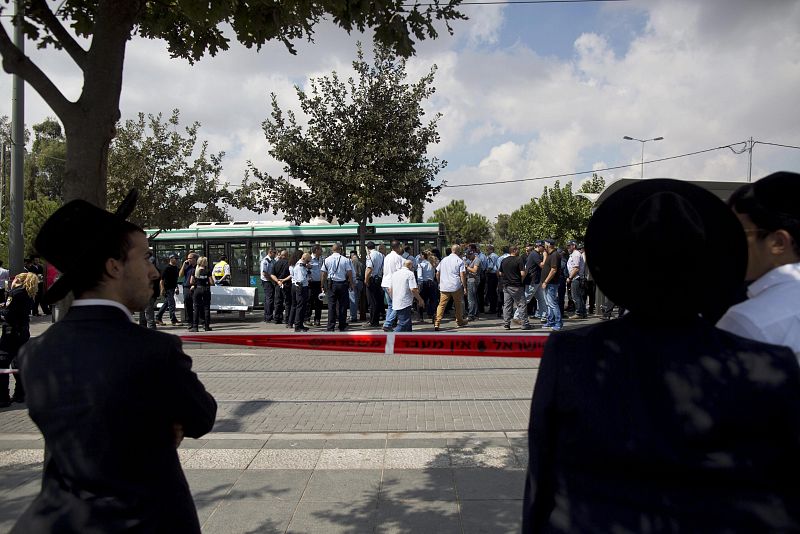 Miembros de la policía israelí (c) trabajan en el lugar del suceso después de que un palestino atacara a un israelí con un arma blanca en el centro de Jerusalén