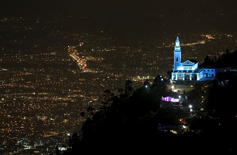 Monserrate mountain and its church are pictured as the building is lit up in blue to honor the 70th anniversary of the United Nations in Bogota