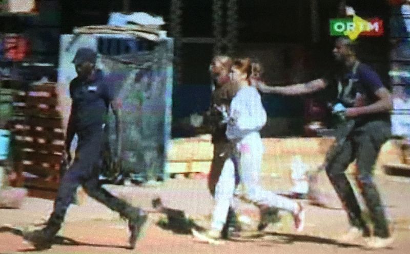 Still image from video shows a hostage rushed out of the Radisson hotel in Bamako, Mali