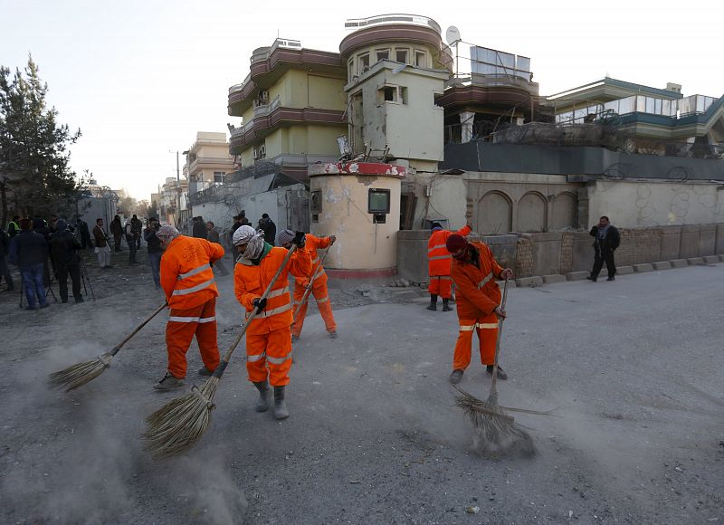 Trabajadores afganos limpian los escombros producidos por el ataque cerca de la embajada española en Kabul