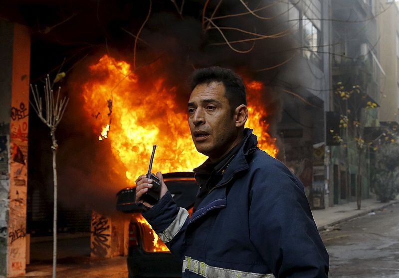 Fireman calls for help during a 24-hour general strike in central Athens,