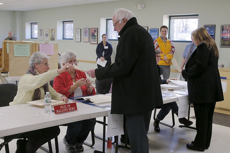 El candidato a la nominación demócrata, Bernie Sanders, recoge sus papeletas junto a su mujer Jane para votar en Burlington, en el estado de Vermont