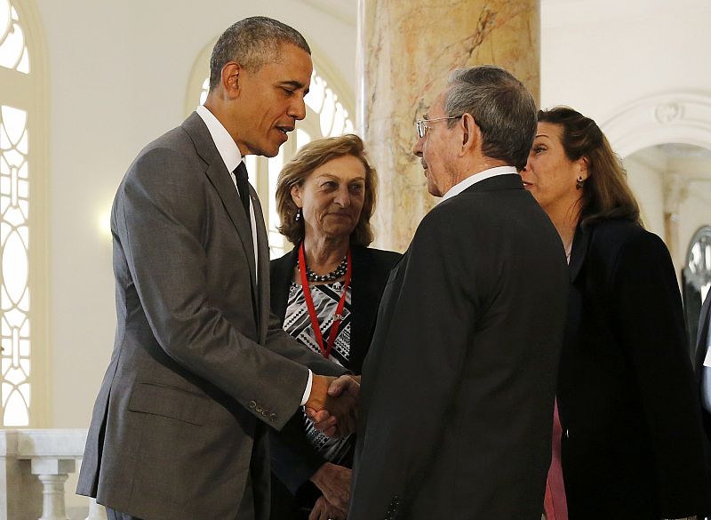 Cuba's President Raul Castro greets U.S. President Barack Obama before Obama makes a speech in a Havana theater