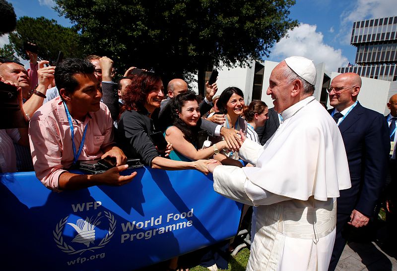 Pope Francis greets workers during a visit at the United Nations World Food Programme (WFP) headquarters in Rome