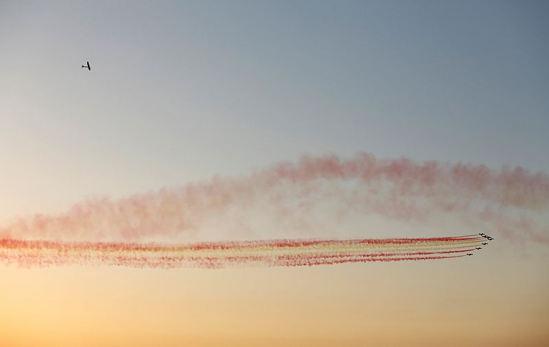 Solar Impulse 2 flies over Spanish air force aerobatic team Patrulla Aguila before landing at San Pablo airport in Seville, southern Spain