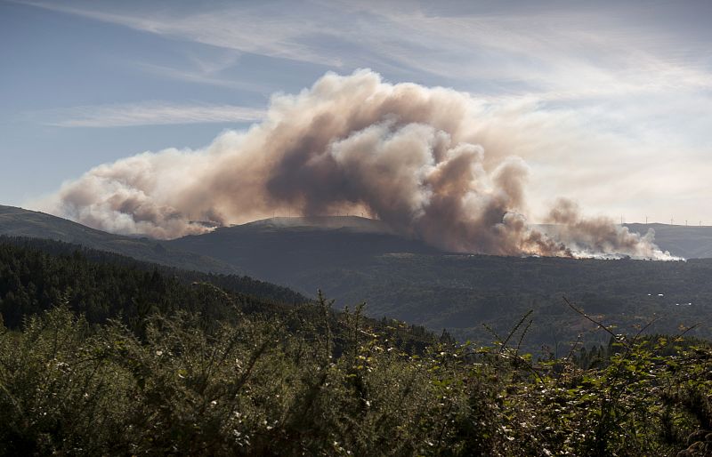 Humo que asciende del incendio declarado en la parroquia de la Nieva