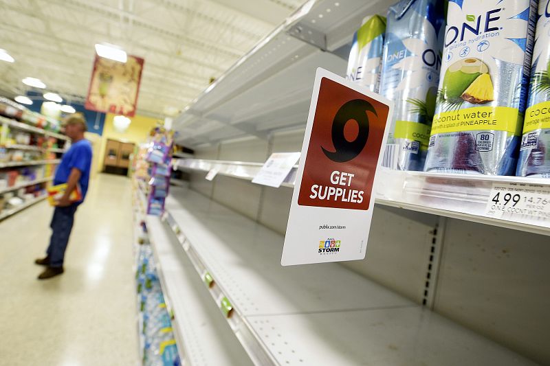 Shelves formerly holding water bottles sit empty at a supermarket before the arrival of Hurricane Matthew in South Daytona