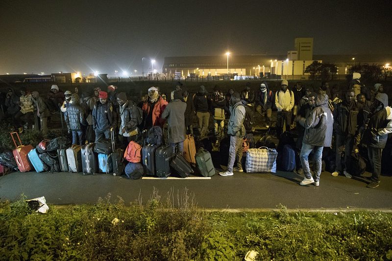 Decenas de personas hacen cola para ser evacuados del campamento de Calais, que se ha ido formando desde 2015 con sucesivas oleadas de refugiados que esperaban poder cruzar al Reino Unido. La mayoría provienen de Eritrea, Sudán y Afganistán.