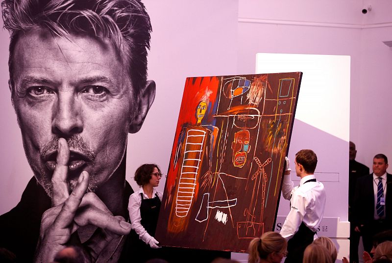 Jean-Michel Basquiat's 'Air Power', owned by the late David Bowie, is removed from a plinth after selling for Â£6,200,000 at  the "Bowie/Collector" auction, at Sotheby's in London