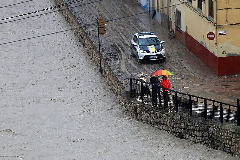 Un coche de la Policía Local en el barrio de la canterería de Ontinyent que ha sido desalojado debido al fuerte temporal de lluvia y viento que afecta a la Comunidad Valenciana.