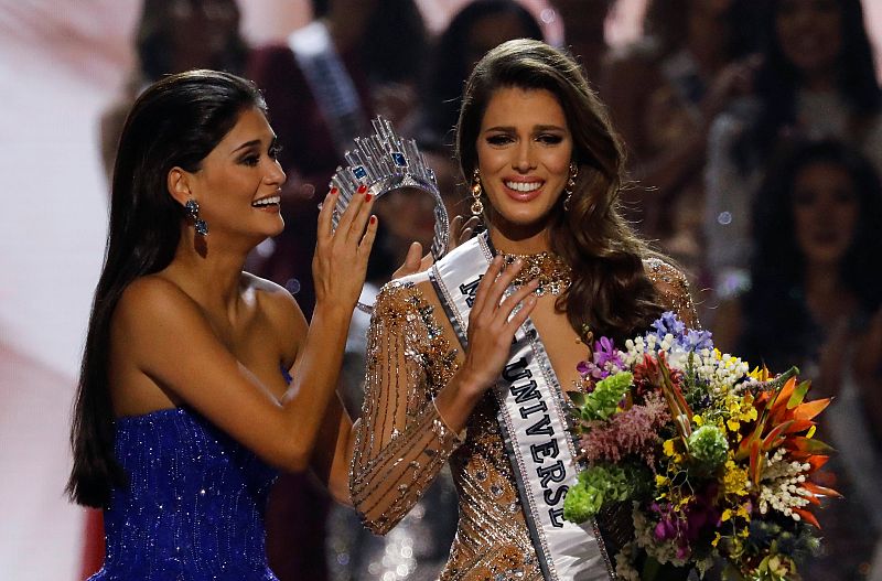 Miss France Iris Mittenaere reacts before Pia Wurtzbach places crown on her during the 65th Miss Universe beauty pageant at the Mall of Asia Arena, in Pasay, Metro Manila