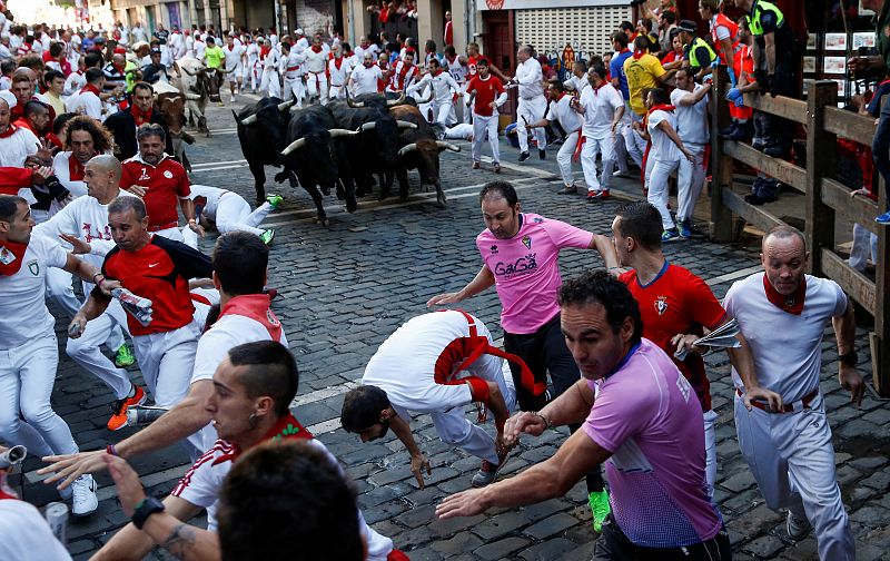 Runners sprint ahead of bulls at the San Fermin festival in Pamplona