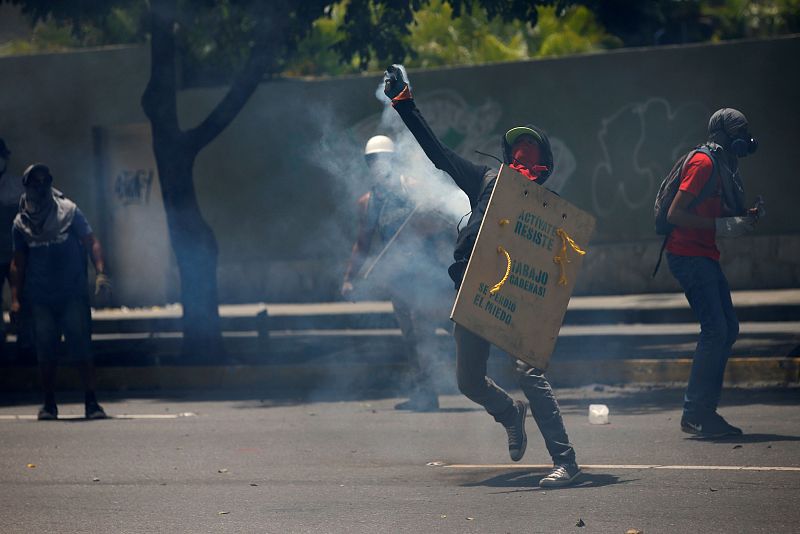 Demonstrators clash with riot security forces while participating in a strike called to protest against Venezuelan President Nicolas Maduro's government in Caracas