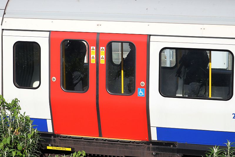 Armed police officers walk through a carriage of a London underground tube train at Parsons Green station in London, Britain