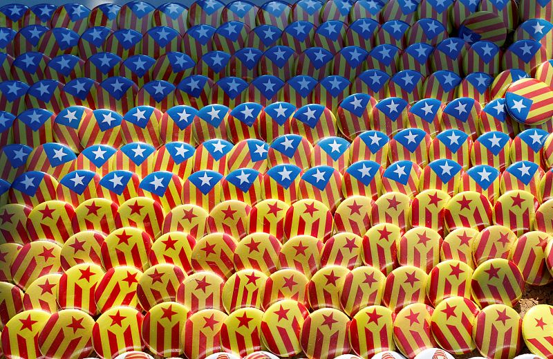 Pins with the colors of Catalan separatist flags are seen at a stand near the Catalan regional parliament as demonstrators started to gather in Barcelona