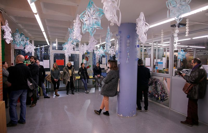 People wait to vote in Catalonia's regional elections at a polling station in Barcelona