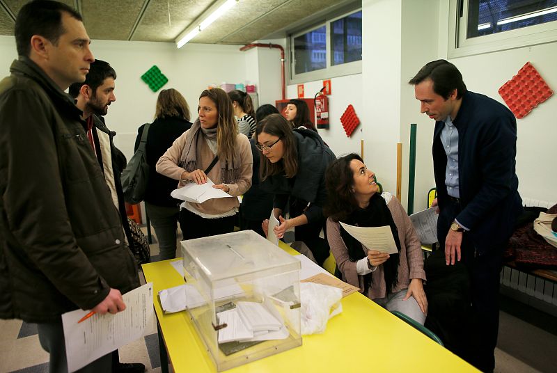 Electoral workers and representatives of political parties prepare a polling station for Catalonia's regional elections in Barcelona