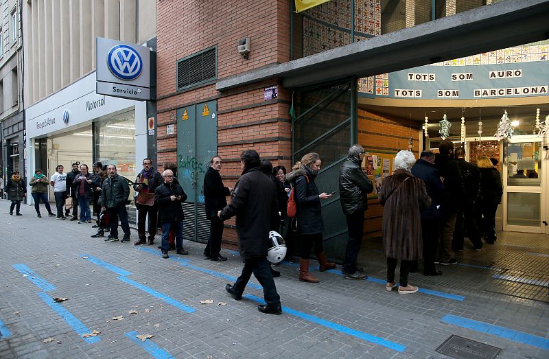 People wait to vote in Catalonia's regional elections at a polling station in Barcelona