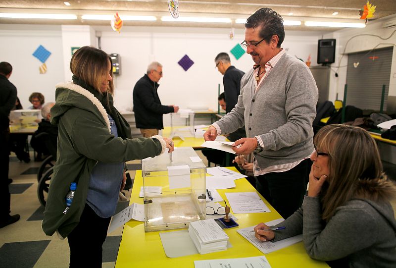 A woman votes in Catalonia's regional elections at a polling station in Barcelona