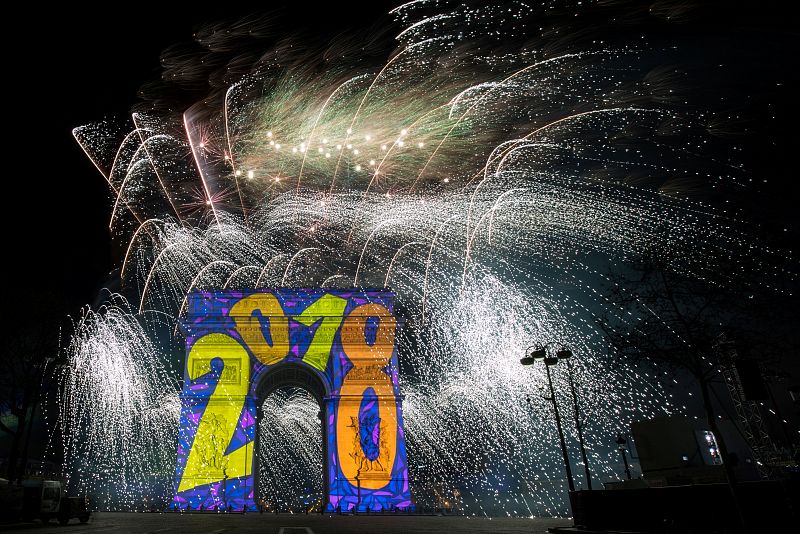 Fireworks light the sky over the Arc de Triomphe on the Champs Elysees Avenue in Paris