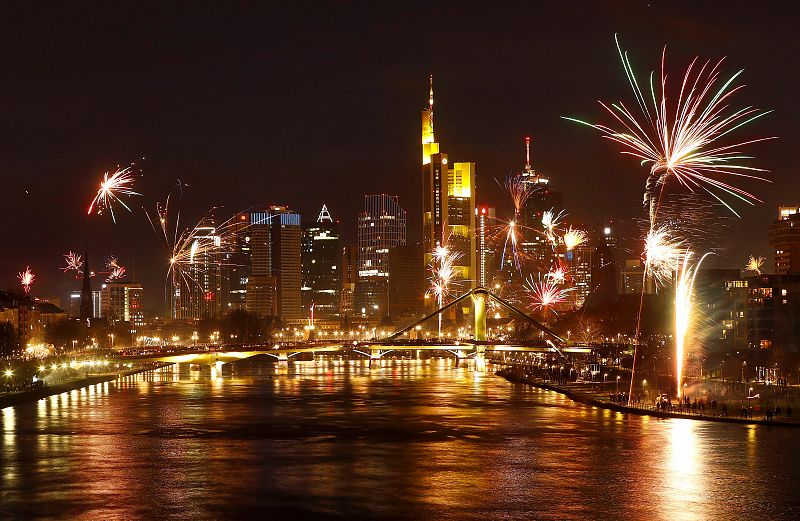 Fireworks explode in front of the skyline with the financial district during New Year's eve celebrations in Frankfurt