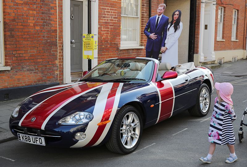 A Jaguar convertible with a Union Flag paint scheme and lifesize cardboard cut outs of Britain's Prince Harry and his fiancee Meghan Markle is parked in Windsor a day before their wedding at Windsor Castle