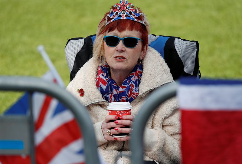 A royal fan waits behind barriers on The Long Walk leading to Windsor Castle on the day before the wedding of Britain's Prince Harry and Meghan Markle in Windsor