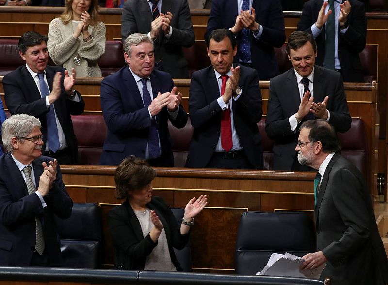 Spain's Prime Minister Mariano Rajoy is applauded by party members during a motion of no confidence debate at Parliament in Madrid