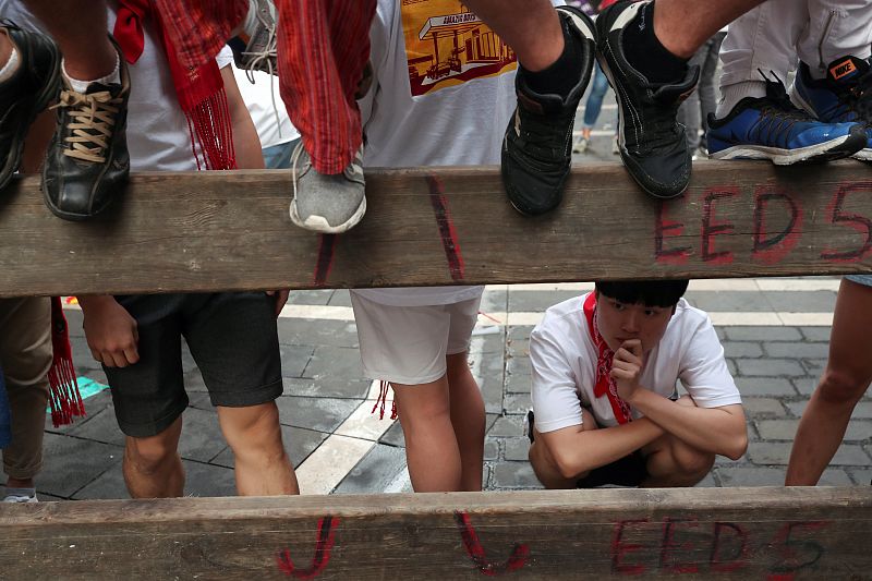 Revellers wait for the start of the sixth running of the bulls of the San Fermin festival in Pamplona